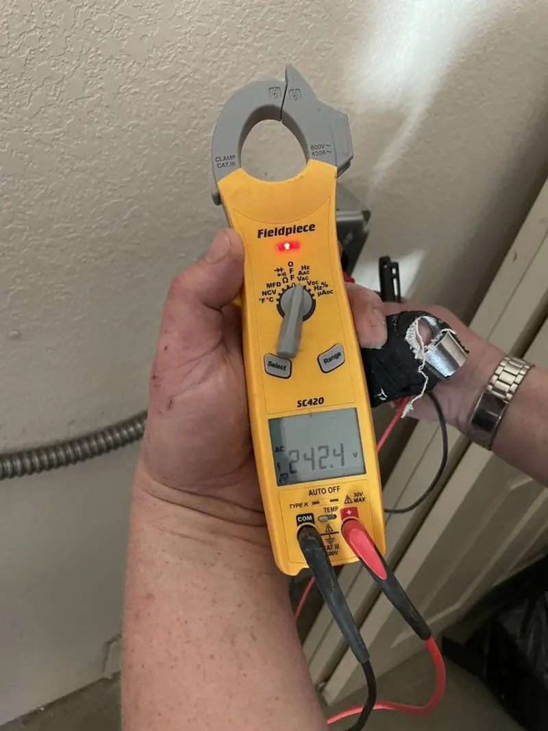 Voltage testing with clamp meter during Outlet Installation in Stacy